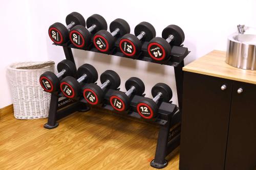 a rack filled with black dumbbells in a room at Park Inn by Radisson Poznan in Poznań