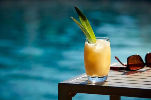 a drink sitting on a table next to a pool at Tivoli Lagos in Lagos