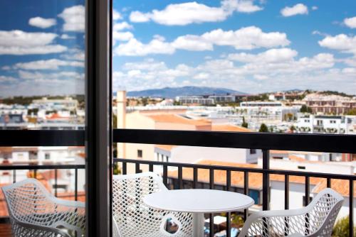a view from a balcony with a table and chairs at Tivoli Lagos in Lagos
