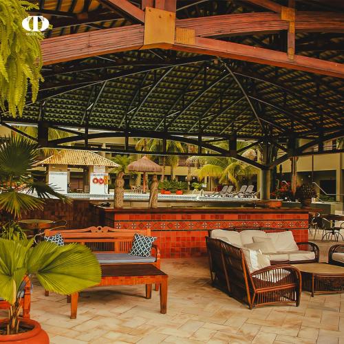 a patio with chairs and a bar in a building at Hotel OT in Três Lagoas
