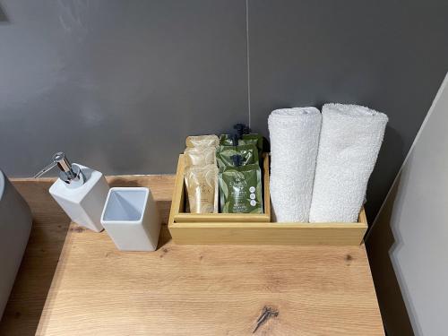 a wooden shelf with toilet paper and toilet paper towels at 7Suites in Empoli