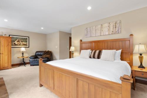 a bedroom with a large bed and a chair at Montebello by Whistler Premier in Whistler