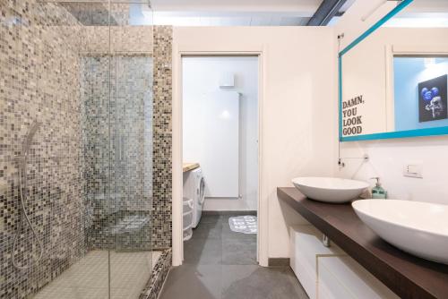 a bathroom with two sinks and a shower at Industrial Loft - Garage-Netflix-wifi in Brescia