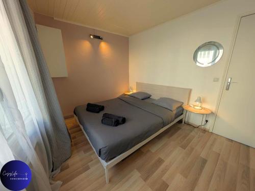 a bedroom with a bed with two bags on it at Le Jardin d'Angély by CozyLife Central Jardin in Niort