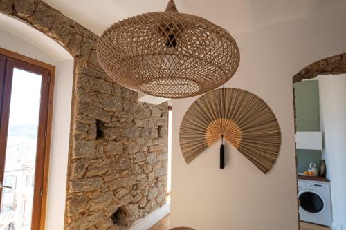 a ceiling light and a fan in a room at Lume appart vue mer au coeur ville à deux pas plage port citadelle in Calvi
