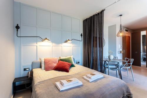 a bedroom with a large bed with two towels on it at Warsaw Concierge Lake Pool Gym in Zegrze Południowe