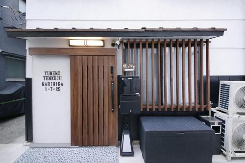 a wooden door with a sign on the side of a building at 夢の天空樹 027t in Tokyo