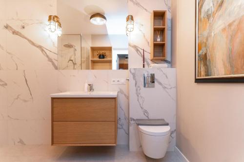 a bathroom with a sink and a toilet at Warsaw Concierge Lake Pool Gym in Zegrze Południowe