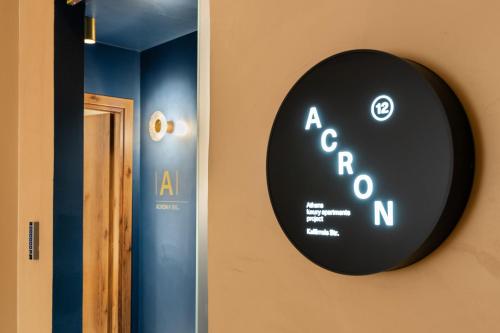 a black sign on the side of a wall at ACRON 12 penthouse Acropolis suites in Athens