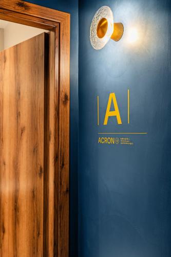 a room with a blue wall with a sign on it at ACRON 12 penthouse Acropolis suites in Athens