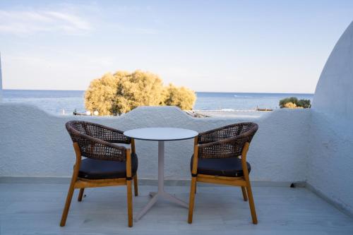 two chairs and a table on a balcony with the ocean at Zen Suites & Spa in Perissa