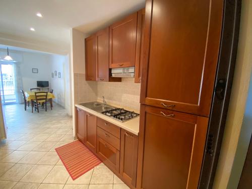 cocina con armarios de madera y cocina con mesa en Bilocale Villa Marina a pochi passi dal mare di Ceriale, en Ceriale