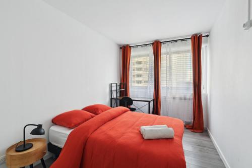 - une chambre avec un lit et une couverture orange dans l'établissement Chic and spacious apart with parking, à Colombes