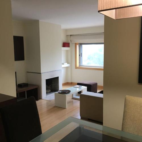 a living room with a couch and a fireplace at Oporto Spacious AP 4 bedroom in Pedrouços