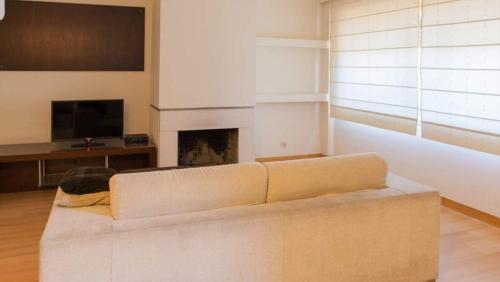 a living room with a couch and a fireplace at Oporto Spacious AP 4 bedroom in Pedrouços
