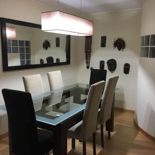 a dining room with a glass table and chairs at Oporto Spacious AP 4 bedroom in Pedrouços