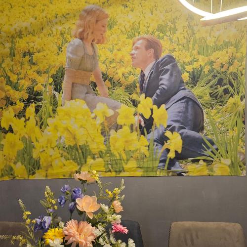 a mural of a man and woman sitting in a field of flowers at 놀거리가 가득한, 대전 둔산동 31평 파크오브파티룸 -숙소가 아닌 공간대여 파티룸 in Daejeon