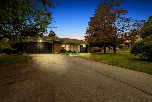 a house with a driveway in front of a house at Comfort, Fun, & Charming - 5BR Oasis with Pool in Coatesville