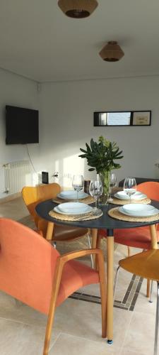 a dining room with a black table and chairs at Mirador de Usil in Mogro