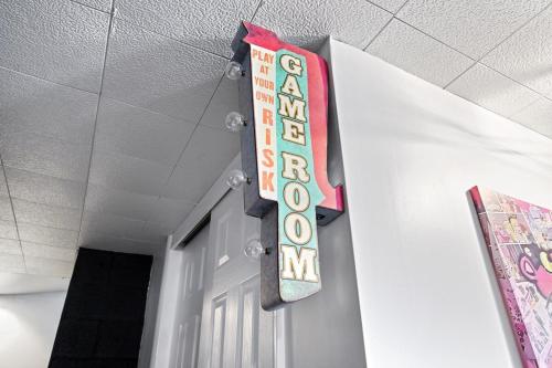a sign hanging from the ceiling of a hallway at Comfort, Fun, & Charming - 5BR Oasis with Pool in Coatesville