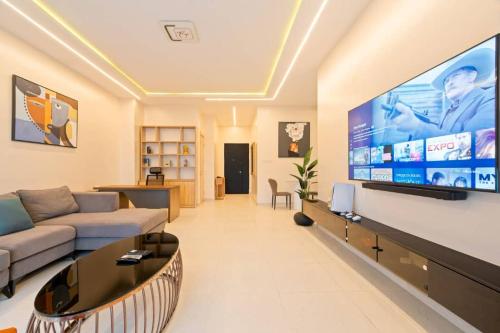 a living room with a large flat screen tv at Zuma- Tan in Bamgbose