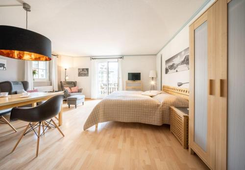 a bedroom with a bed and a desk and a desk at Chasa Valluns 5306 - Studio in Vulpera
