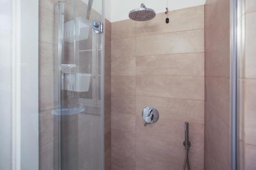 a bathroom with a shower with a glass door at Carlo Alberto 46 in Pavia