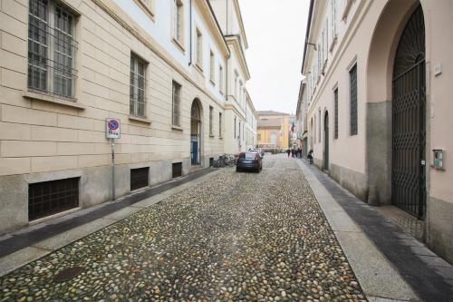 a car parked on a street between two buildings at Carlo Alberto 46 in Pavia