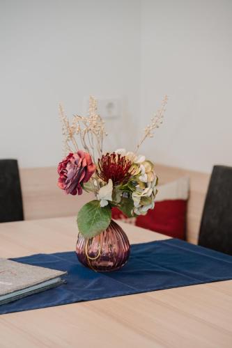 a vase with flowers in it on a table at Pension Bacherhof in Mariapfarr