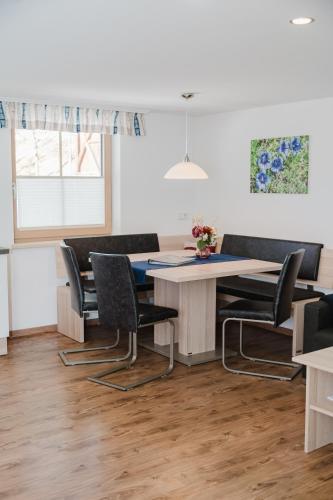 a dining room with a table and chairs at Pension Bacherhof in Mariapfarr