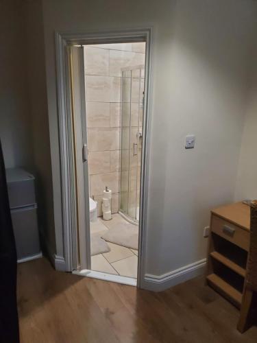 a glass door leading to a shower in a bathroom at En suite bedrooms, Heaton, Newcastle in Newcastle