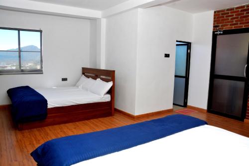 a bedroom with two beds and a window at High Cliff Villa in Nuwara Eliya
