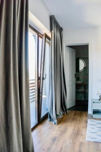 a room with curtains and a large window at Pensiunea CityView in Câmpulung Moldovenesc