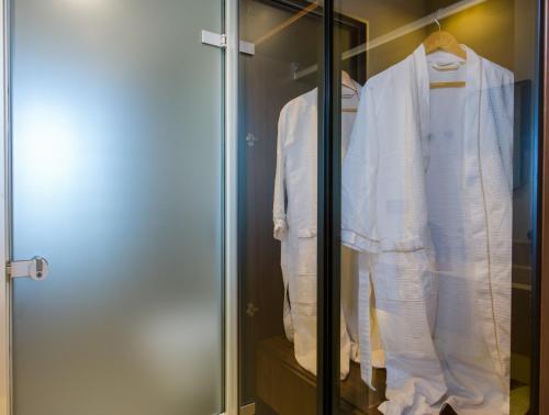 a display case with white clothes in a closet at Almi-Cove Hilltop Villas in Almirida