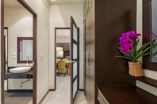 a bathroom with a sink and a mirror at Villa Anatta for your serene vacation in Ban Saiyuan (1)