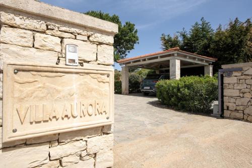a sign for a villa in a parking lot at Villa AuroraLuxurius Living in Prinés