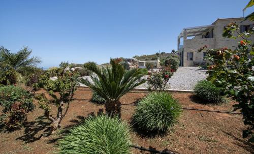 a garden with trees and plants in front of a building at Villa AuroraLuxurius Living in Prinés