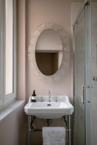 une salle de bain avec un lavabo et un miroir dans l'établissement Appartement de charme dans le centre de Rouen, à Rouen