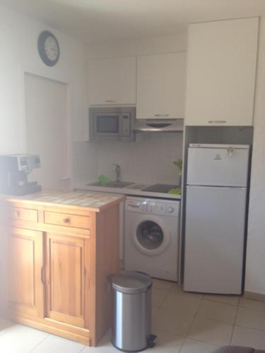une cuisine avec un réfrigérateur et une machine à laver dans l'établissement Charmant T2 climatisé avec terrasse - 200 m de la plage - les Boramars, à Argelès-sur-Mer