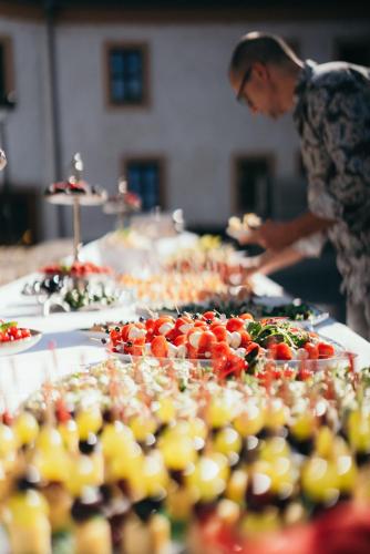 a man standing in front of a buffet of food at Hotel Schloss Schkopau in Schkopau