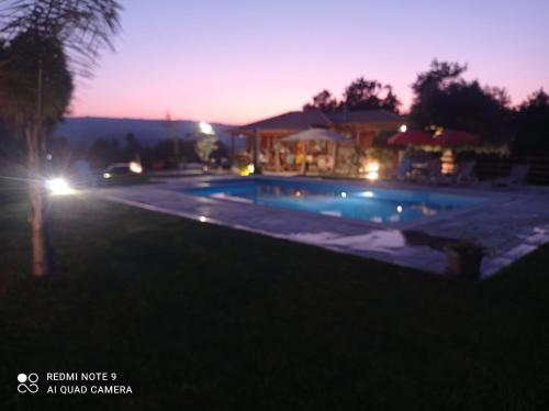 a swimming pool in a yard at night at O Barraco Martins T1 in Mondim de Basto