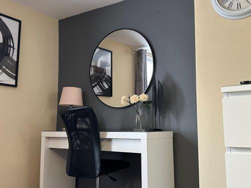 a room with a desk with a mirror and a chair at Llanidloes Townhouse-pet-friendly-sleeps 7-Mid Wales in Llanidloes