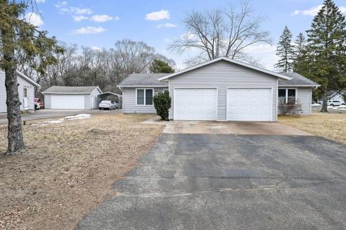 a house with a garage and a driveway at The Cozy and Quaint Duplex in Point in Stevens Point