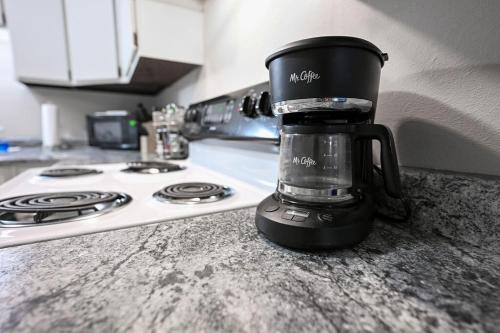 a coffee cup sitting on a counter next to a stove at The Cozy and Quaint Duplex in Point in Stevens Point