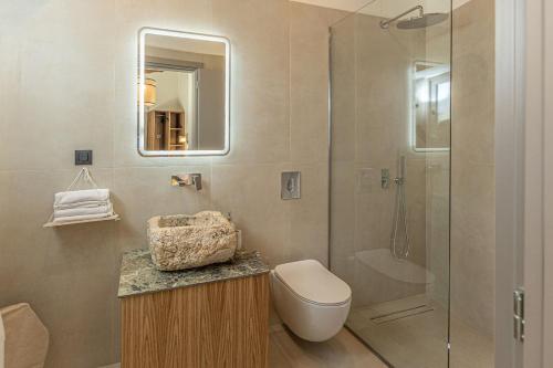 a bathroom with a toilet and a shower at Luxury Villa Platon with Private Pool in Plaka