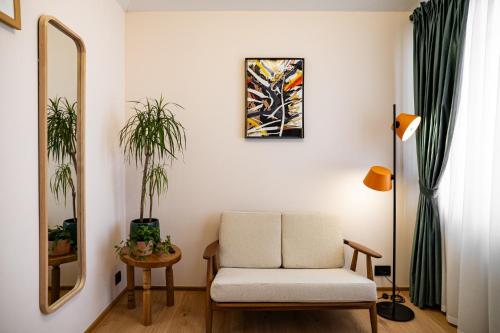 a living room with a chair and a mirror at 7oaks Noble House in Dubrovnik
