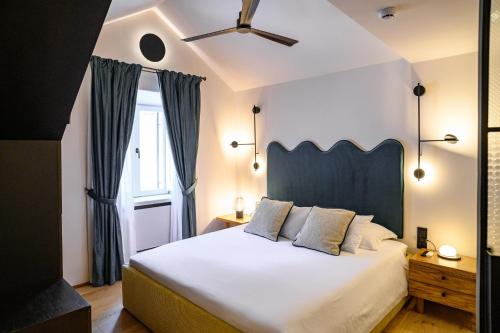 a bedroom with a large white bed and a window at 7oaks Noble House in Dubrovnik