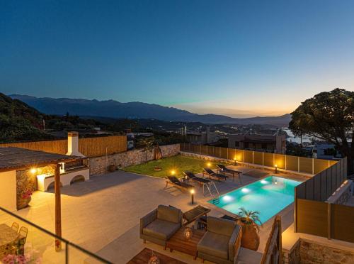 a rooftop patio with a swimming pool and patio furniture at Luxury Villa Platon with Private Pool in Plaka