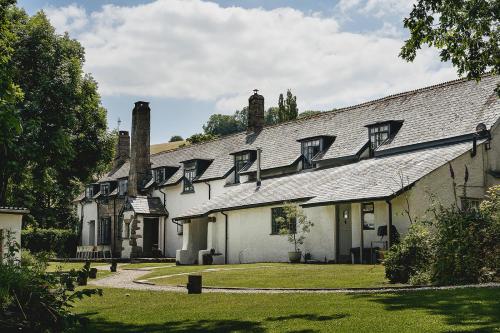 a large white building with a roof with windows at Weeke Barton in Exeter
