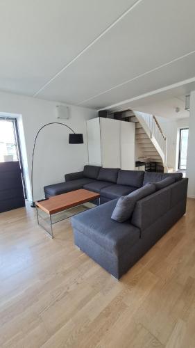 a living room with a couch and a table at Two-story four-room apartment in Copenhagen